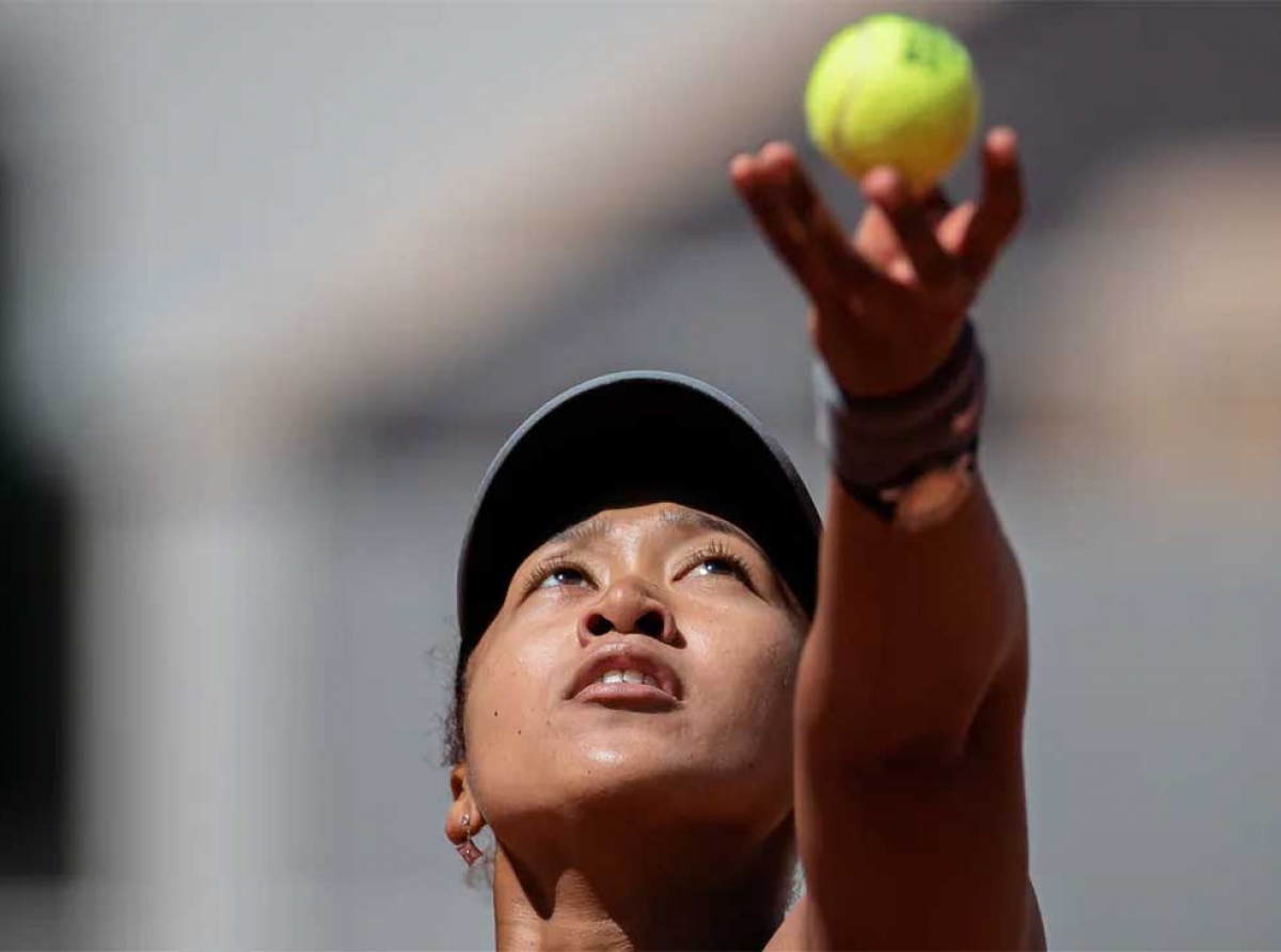 Naomi Osaka keeps her eye on the ball as she prepares to serve. Aurelien Morissard/Xinhua via Getty Images