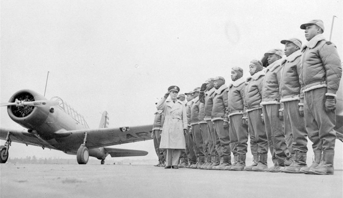 FILE - Major James A. Ellison, left, returns the salute of Mac Ross of Dayton, Ohio, as he inspects the cadets at the Basic and Advanced Flying School for Black United States Army Air Corps cadets at the Tuskegee Institute in Tuskegee, Ala., in Jan. 23, 1942. For Veterans Day, a group of Democratic lawmakers is reviving an effort to pay the families of Black servicemen who fought on behalf of the nation during World War II for benefits they were denied or prevented from taking full advantage of when they returned home from war. (AP Photo/U.S. Army Signal Corps, File)