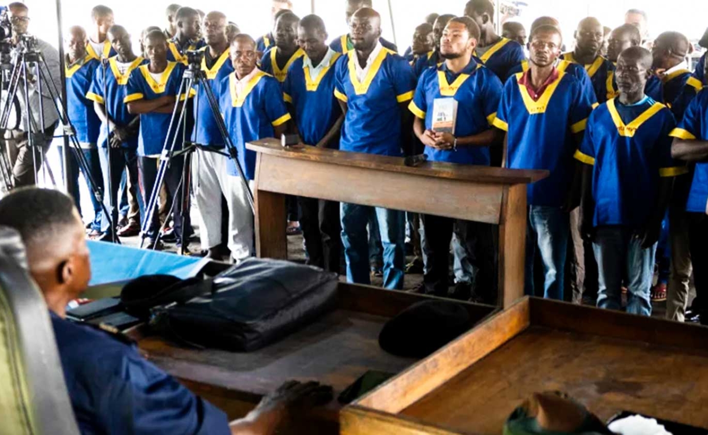   American Marcel Malanga, fourth right, stands with others during a court verdict in DRC, Kinshasa, Friday Sept .13, 2024, on charges of taking part in a coup attempt in May 2024. Samy Ntumba Shambuyi/AP 