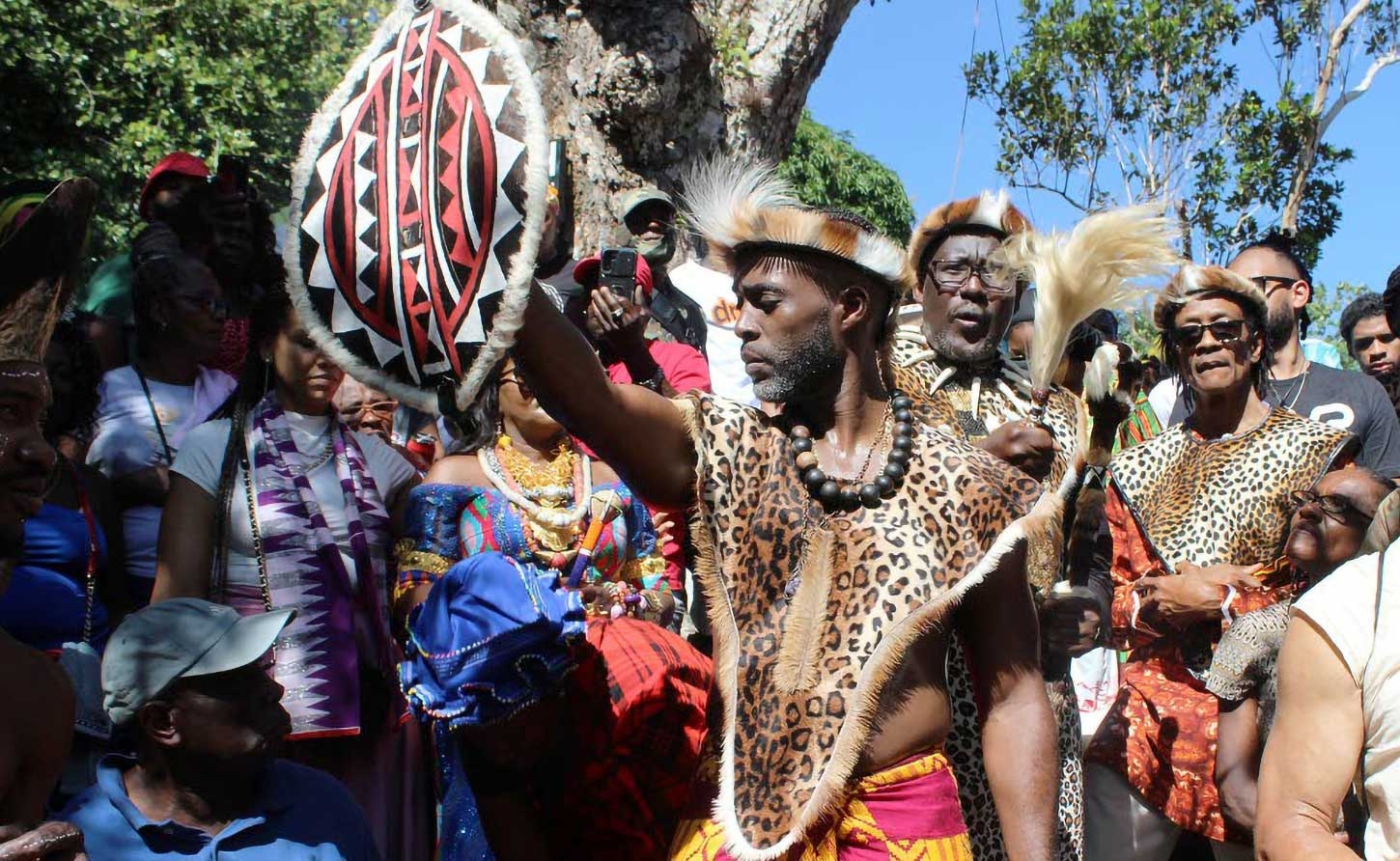 Accompong Maroon Chief Richard Currie holds aloft the gift he got from His Royal Highness Papa ATEKER Paul Jones Eganda, president of AIDO International/Uganda Global Afraka,