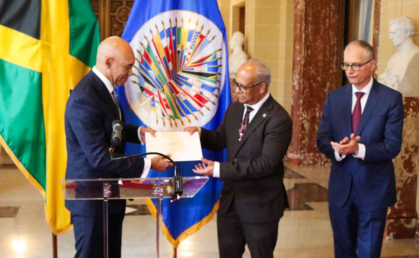 Jamaica’s Ambassador to the United States and Permanent Rep to the OAS, Major Gen. (Rtd) Anthony Anderson presents his credentials to the Secretary General of the OAS, H. E. Albert Ramdin on June 18. At left is Assistant Secretary General , Amb Nestor Mendez. | Derrick Scott Photo.