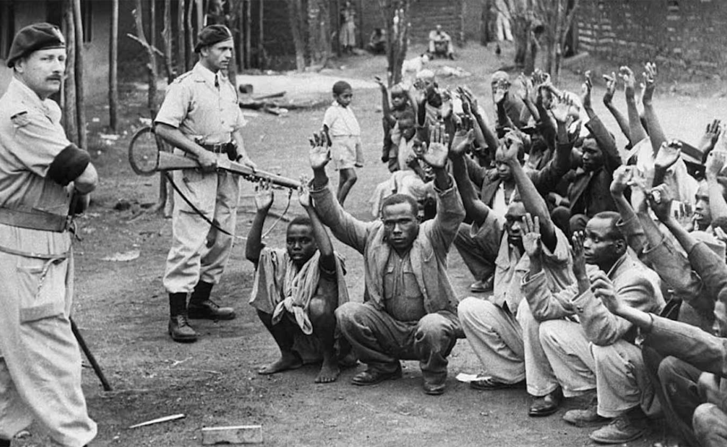 British policemen hold men from the village of Kariobangi at gunpoint while their homes are searched for evidence that they participated in the Mau Mau rebellion of 1952. Getty Images