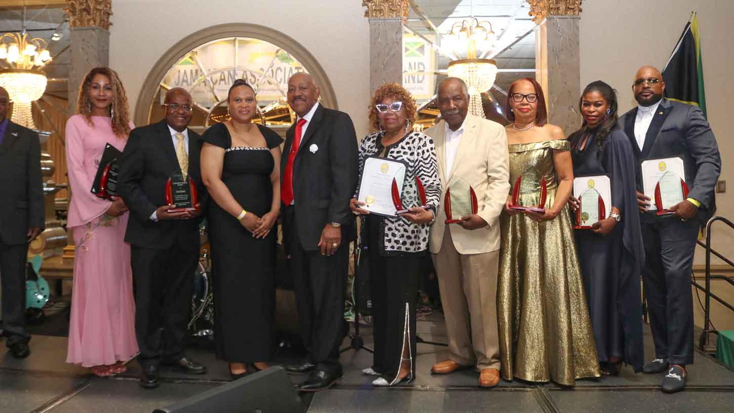 Chargé d’Affaires, a.i., at the Embassy of Jamaica, Washington D.C., Ms. Lishann Salmon (third left), JAM President and CEO Ricardo “Rick” Nugent (sixth right), shares a light moment with the 2026 JAM Awardees. From left to right, Janet Abrahams, Errol Smith, Dr. Elaine Simon, Kenneth ‘Kenny’ Brown, Claire Robinson, Sandy Tucker, and Jazz Tucker after they received their awards at the Jamaican Association of Maryland’s (JAM) 64th Annual Independence Gala, held Saturday, August 8, 2026 at Martin’s West. (Photo Derrick Scott).