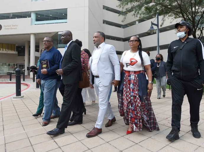 Attorney Ben Crump, second from left, walks with Ron Lacks, left, Alfred Lacks Carter, third from left, both grandsons of Henrietta Lacks, and other descendants of Lacks, outside the federal courthouse in Baltimore in 2021. Novartis settled a lawsuit with the Lacks estate this month that alleged the pharmaceutical giant unjustly profited off her cells. AP Photo/Steve Ruark, File