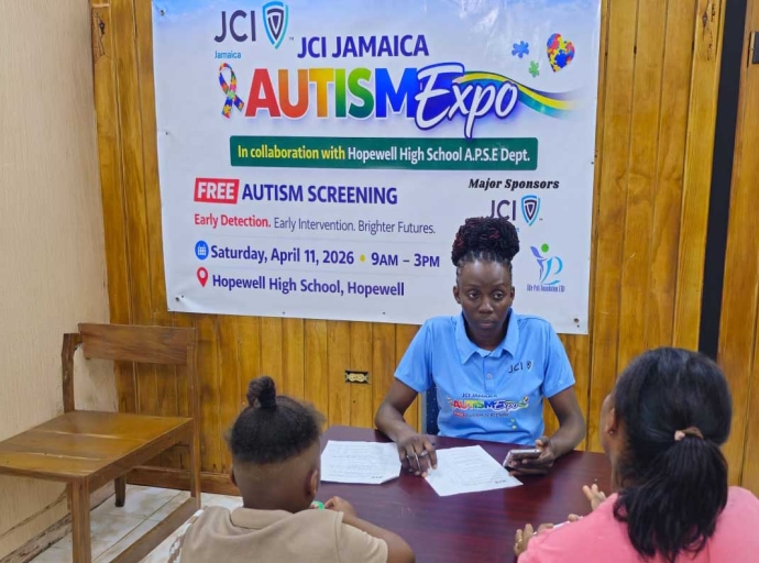 Dr. Yochel Samuels-Williams, Immediate Past President of JCI Hopewell, formerly Hopewell Jaycees with a parent and her child at the JCI Jamaica Autism Expo in Hopewell, Hanover.