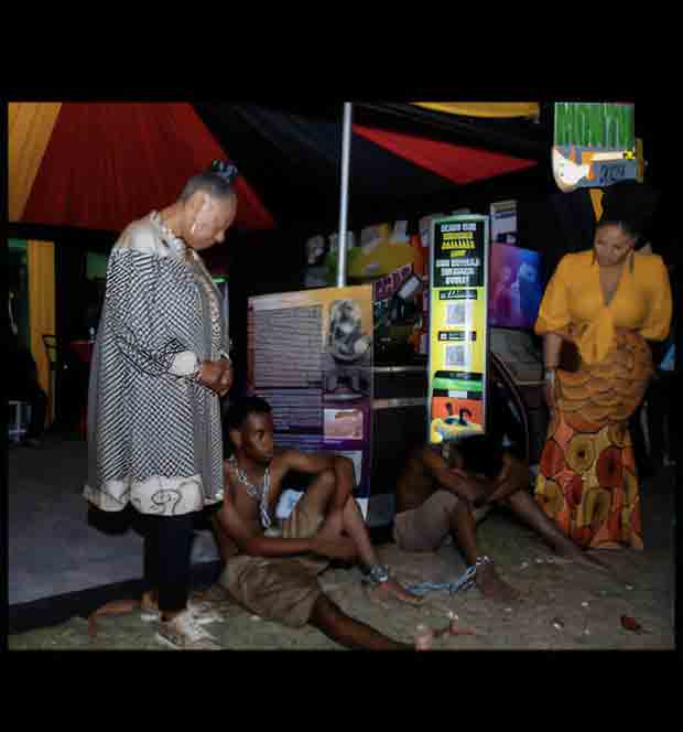 Olivia Grange, Minister of Culture, Gender, Entertainment and Sport, Jamaica pauses in scene of a skit depicting slavery