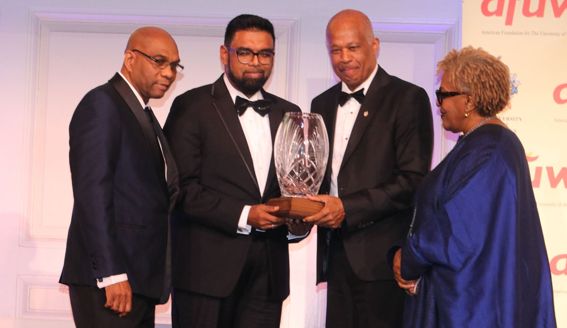 President of Guyana His Excellency Dr. Mohamed Irfaan Ali accepts the Legacy Award from Vice Chancellor of the University of the West Indies from Professor Hilary Beckles at  the American Foundation for The University of the West Indies annual gala in Manhattan on Thursday April 18, 2024.At Left is AFUWI Board member Dr. Ron Chase, while at right is Guyanese-American actress CCH Pounder.