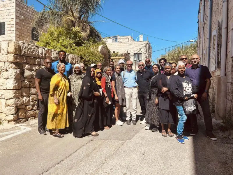 In this photo provided by Black Jerusalem, members of the “Black Jerusalem” trip pose for a photograph in the Ein Karem neighborhood of Jerusalem, on Friday, Sept. 29, 2023. (Black Jerusalem via AP)