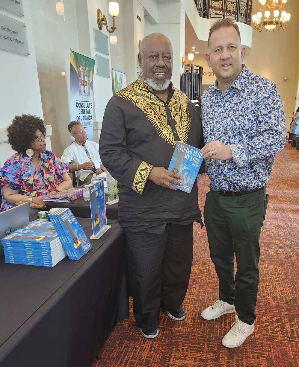 Curtis Myrie shares the lens with Jamaica's Consul General Oliver Mair at the Jamaica Brew Event.