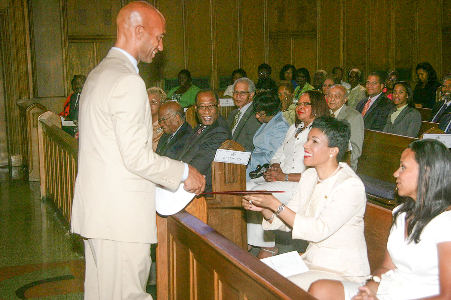 Jamaica’s ambassador to the United States, Her Excellency Audrey Marks, accepts a scroll proclaiming August 6 as “Jamaica’s Independence Day in Washington DC,” from Washington DC  forma Mayor Adrian Fenty  during the Jamaican Independence Service of Thanksgiving at Howard University’s Dumbarton Chapel. At right in Mrs. Michelle Fenty (PHOTO Derrick Scott)