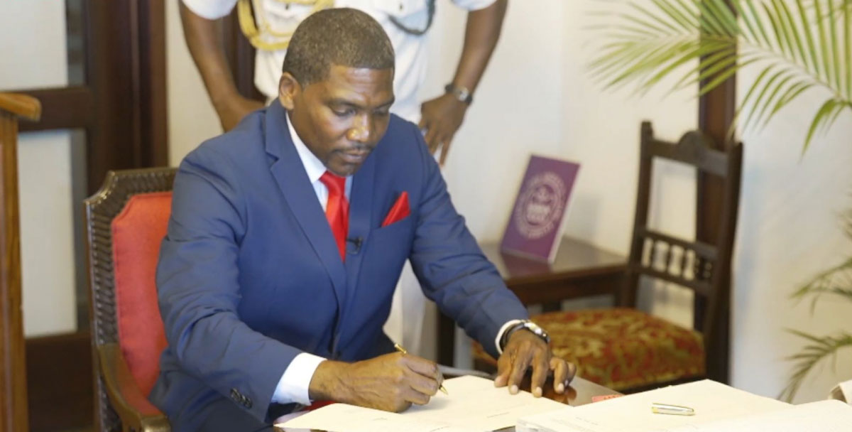 Dr. Terrence Drew signs Oaths of Office after being sworn in as Prime Minister of the Federation of St. Kitts and Nevis on Saturday.