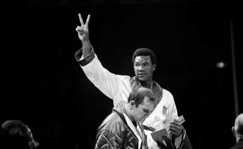 George Foreman flashes a victory sign after his win over Joe Frazier in two rounds of the title fight at Kingston, Jamaica’s National Stadium, Jan. 22, 1973. (AP Photo)