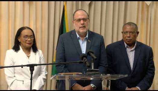 Opposition Leader Mark Golding addresses a media briefing on Tuesday, accompanied by PNP's Constitutional Reform Committee members Donna Scott Mottley and Anthony Hylton.