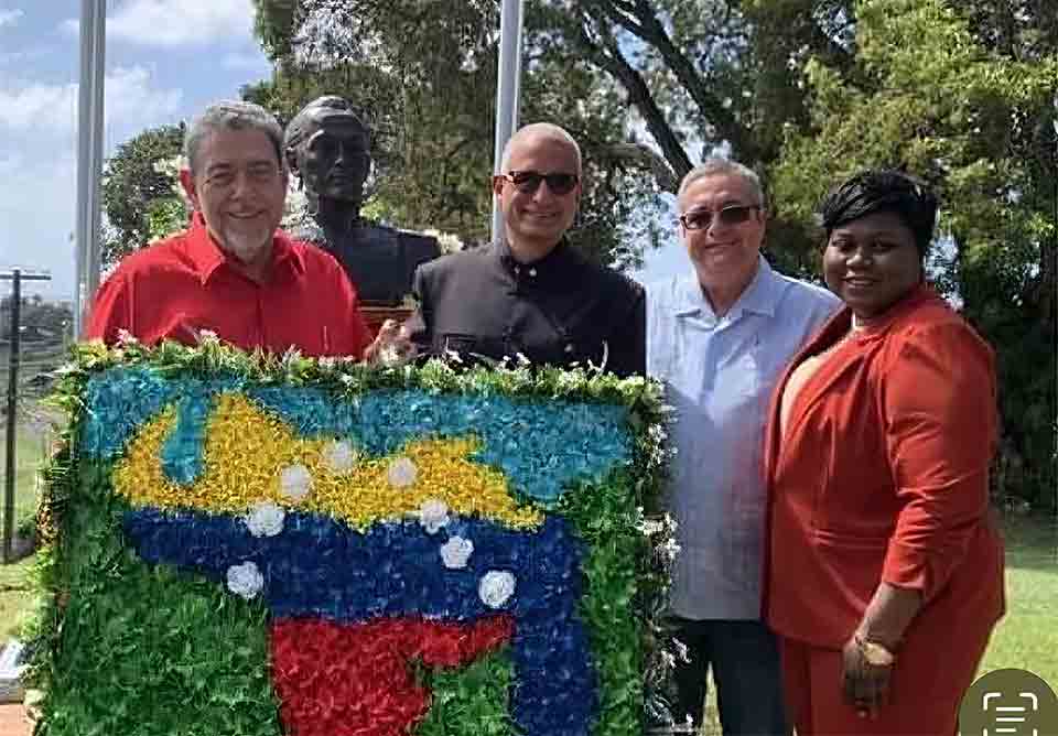 Prime Minister Ralph Gonsalves (left) standing behing an image of the Venezuela man containing theat portion of Guyana being claimed by Venezuela.