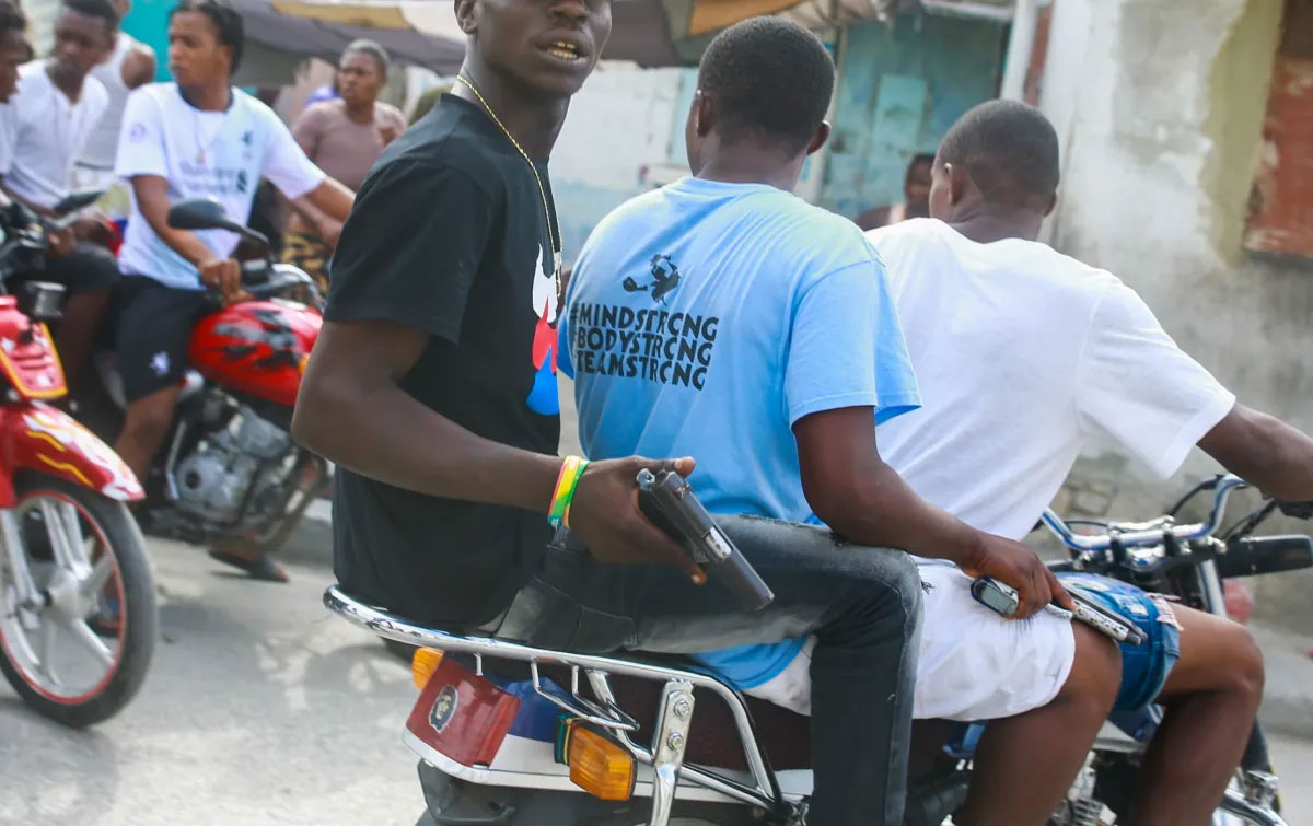 Gang members patrol the street holding guns six months after a massacre in the La Saline slum of Port-au-Prince, Haiti, May 31, 2019. ( Photo/Dieu Nalio Chery)