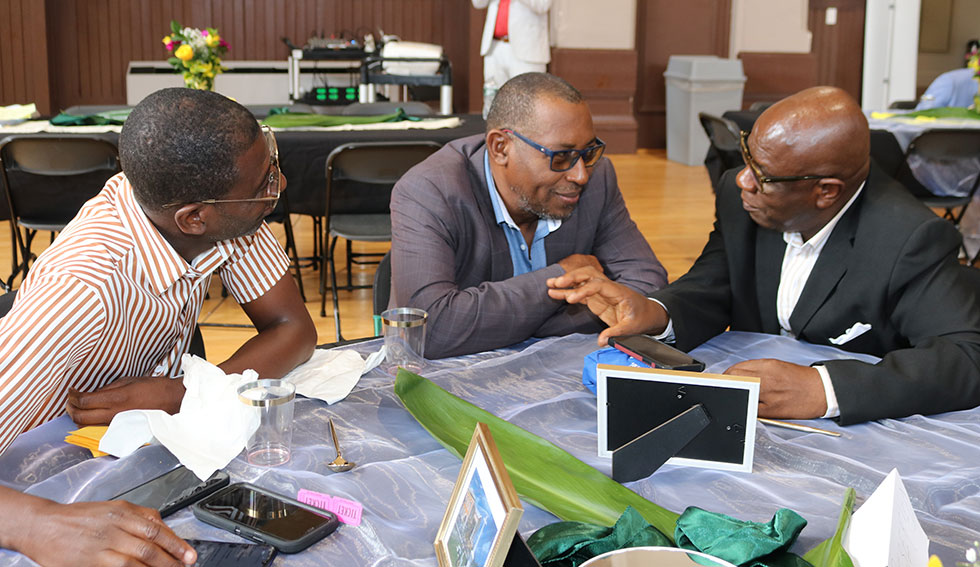 Falmouth’s Mayor Colin Gager engages the  attention of Councillor for the Martha Brae Division Roydell Hamilton and Councillor for the Falmouth Division Garth Wilkinson at theFriends of Falmouth Symposium at the Major Owens Community Centre in Brooklyn New York on Saturday 25th May, 2024.|Derrick Scott Photo