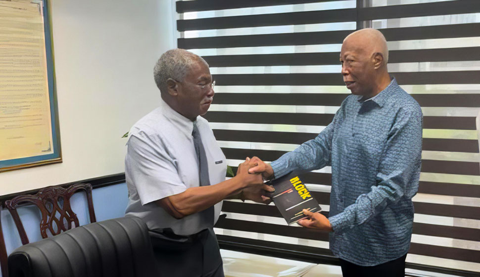 Author and former attorney general of Jamaica A. J. Nicholson, presents a copy of his book entitled book, The Roadblock: Jamaica’s Resistance to the Caribbean Court of Justice, to constitutional law expert Dr. Lloyd Barnett, following the launch of his much acclaimed book at the Faculty of Law, University of the West Indies, Mona. 