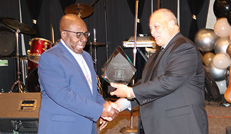 Jamaican Actor and Comedian Oliver Samuels accepts his award for Arts and Culture from President of the  Jamaican Organization of New Jersey (JON-J) Owen Eccles, at the organization’s 25th anniversary gala and Jamaica’s 61st anniversary celebrations at the Newark Airport Marriott Hotel in New Jersey on Saturday August 26, 2023 | Derrick Scott Photo.