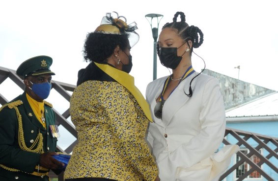 National Hero, The Right Excellent Robyn “Rihanna” Fenty receives her insignia from President of Barbados, Dame Sandra Mason at the National Independence Awards Ceremony today. (B. Hinds/BGIS)