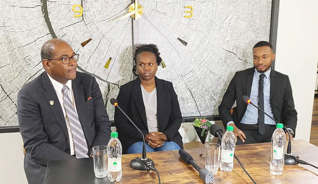 Attorney Tamieka Clarke flanked by her lawyers Nigel Hughes (left) and Shawn Shewram following her arrest last Friday.