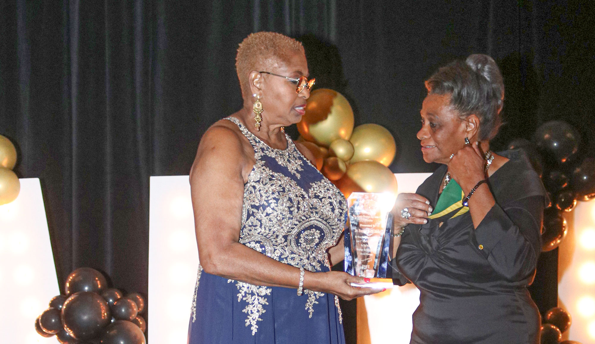 Chair of the Atlanta Montego Bay Sister City Committee Dr.Yvonne Smith receives  and award from Ms Marjorie Wilson in recognition of her outstanding contribution as leader of the organization.The presentation took place at at the  Atlanta-Montego Bay Sister Committee “Dance for Health” fundraiser held Saturday September 24, 2022  at the Atlanta Airport Marriott Gateway Hotel.