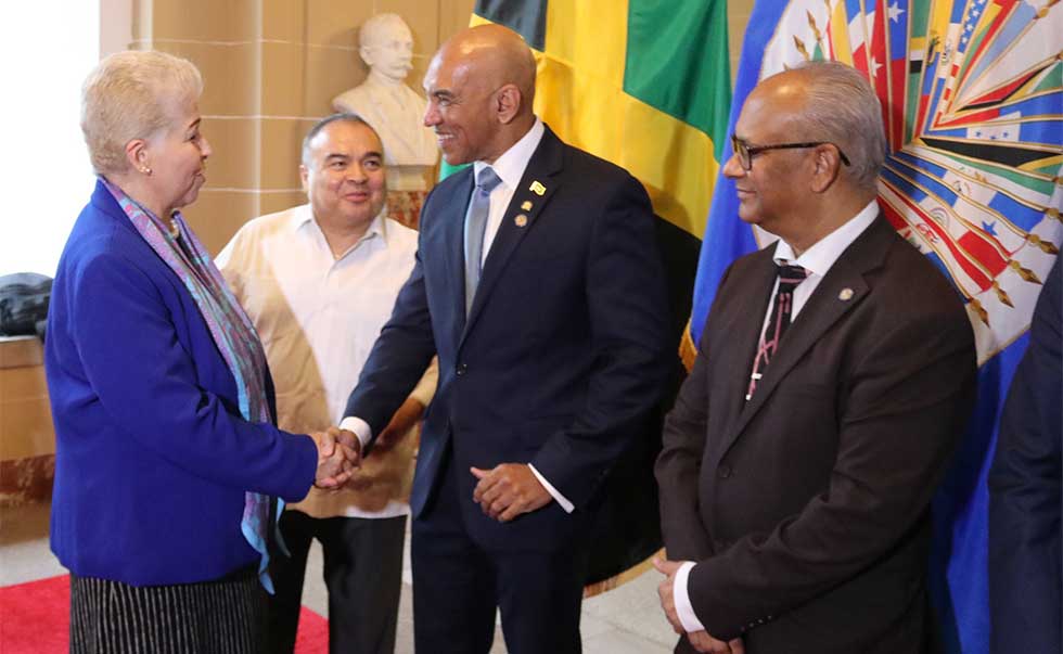 Ambassador Anthony Anderson, receives congratulations from Mexico’s Permanent Representative to the OAS, H.E. Luz Elena Baños Rivas. Sec. Gen. Albert Ramdin and OAS Assistant Secretary General Nestor Mendez look on. Photo Derrick Scott.