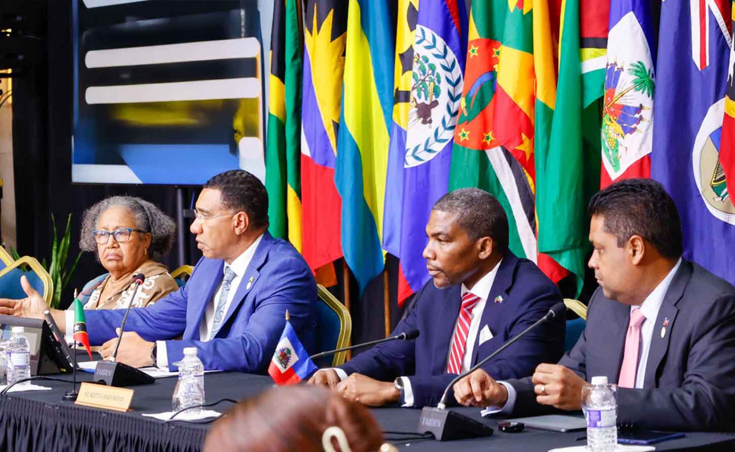 Interim Chair of the Caribbean Community Jamaica's Prime Minister Andrew Holness (asecond left)  and Secrfetary General of the CARICOM community, Dr. Carla Barnett.