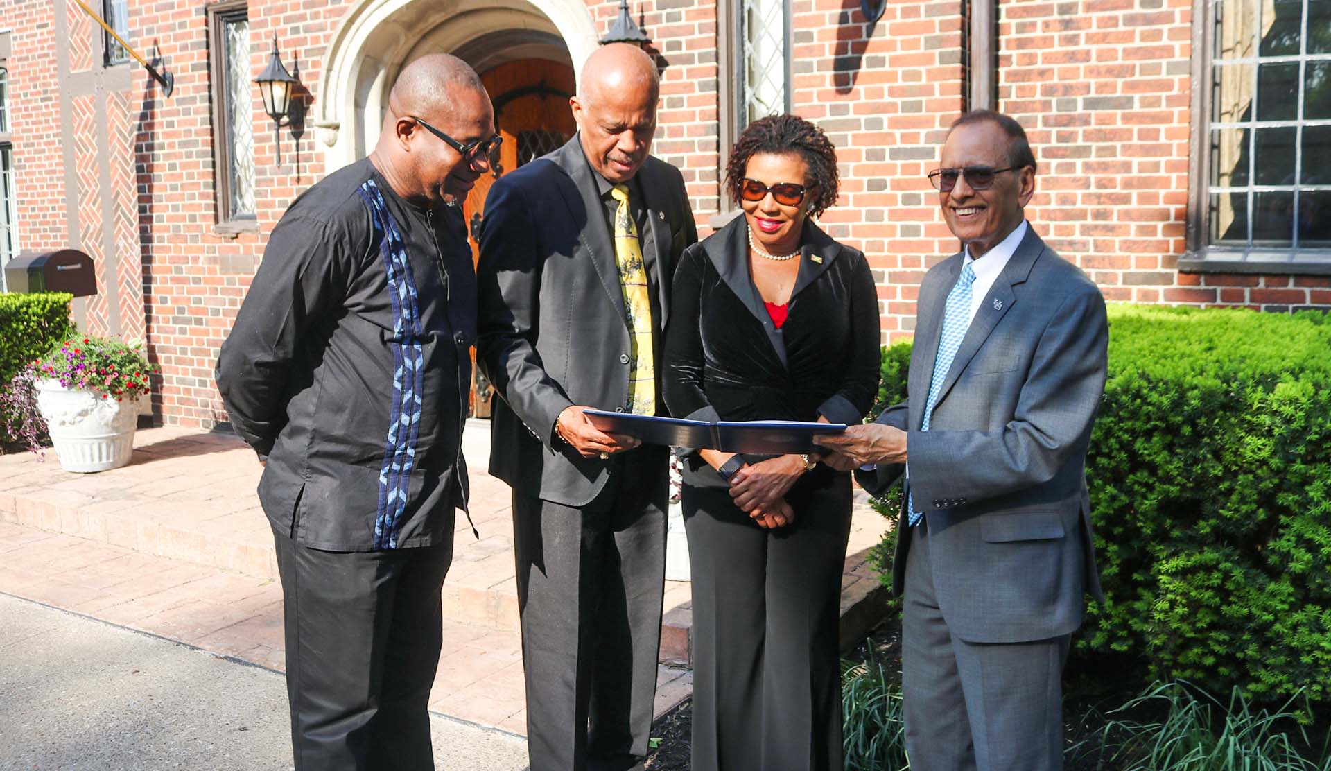 Jamaica’s ambassador to the United States Audrey Marks(centre) along with UWI Mona principal Professort Densil williams, Vice Chancellor Hillary Beckles and  University at Buffalo President Satish K. Tripathi peruse the memorandum of understanding signed between both universities to help achieve the United Nations 2030 Sustainable Development Goals. 