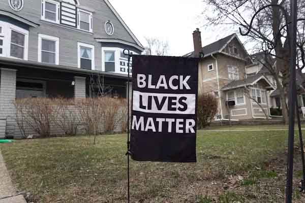 A 'Black Lives Matter' sign sits on a lawn in front of a stately house Evanston, Ill., is the first city in the nation to grant reparations to residents. Scott Olson/Getty Images