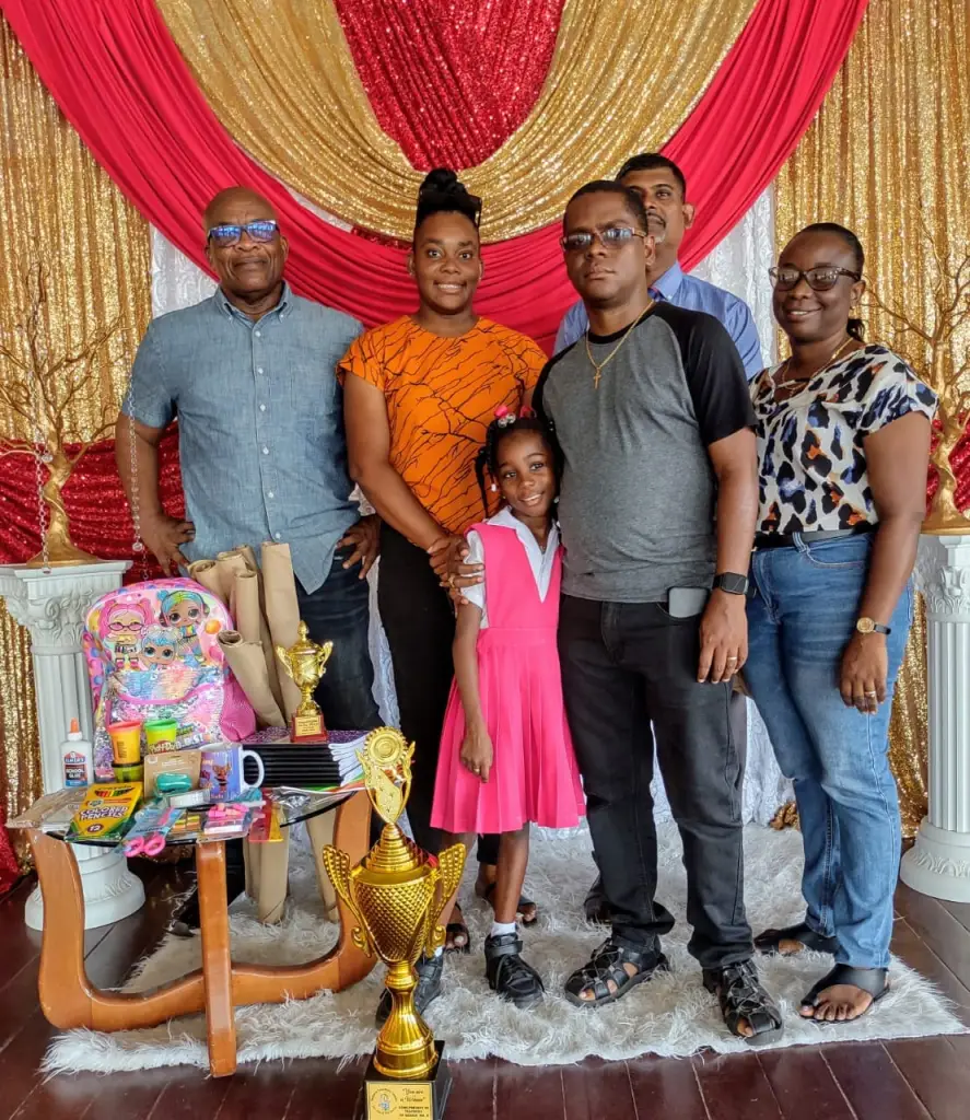 Ezeka Minty and her parents (front row). Back row L-R, former President GTU Colin Bynoe, Mehalai McAlmont and Imran Ally. GTU’s photo