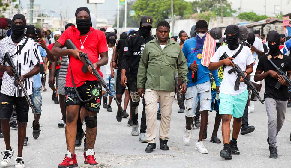 Former police officer Jimmy "Barbecue" Cherizier, leader of the 'G9' coalition, leads a march surrounded by his security against Haiti's Prime Minister Ariel Henry, in Port-au-Prince, Haiti. REUTERS/Ralph Tedy Erol 