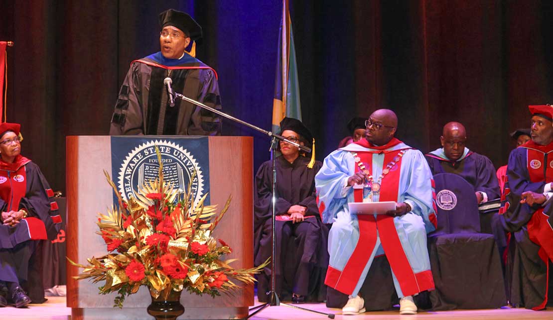 Prime minister Andrew Holness delivers commencement address at Delaware State University at the 2024 commencement ceremony on Friday May 10, at the university’s campus at Dover, Delaware. Looking on at right are Jamaica’s Ambassador to the United States HE Audrey Marks, President Tony Allen and other members of the school’s administration and faculty | Derrick Scott Photo..