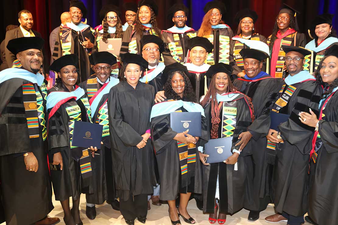 Prime minister Andrew Holness at centre, along with Ambassador Audrey Marks and MP Roberty Montague pose for a photograph with Jamaican graduates of the Delaware State University, at the 2024 commencement ceremony on Friday May 10, at the university’s campus at Dover, Delaware | Derrick Scott Photo.