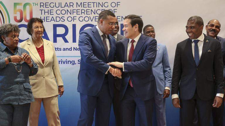 US Secretary of State Marco Rubio shakes hands with Jamaica's Prime Minister Andrew Holness during a photo with Caribbean Community (CARICOM) heads of government in Basseterre, Saint Kitts and Nevis, February 25, 2026. Rubio was meeting with Caribbean leaders seeking a common line on Venezuela and pressure on Cuba.