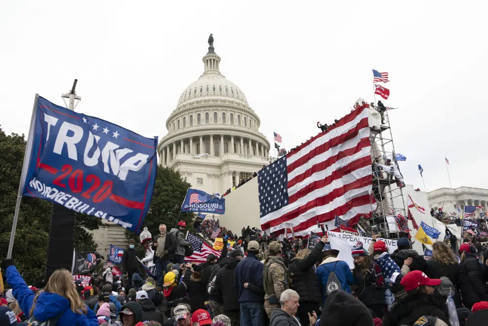 FILE - Violent insurrectionists loyal to President Donald Trump stand outside the U.S. Capitol in Washington on Jan. 6, 2021. On Monday, Dec. 19, the House select committee investigating the Jan. 6 attack on the U.S. Capitol will hold its final meeting. (AP Photo/Jose Luis Magana, File)