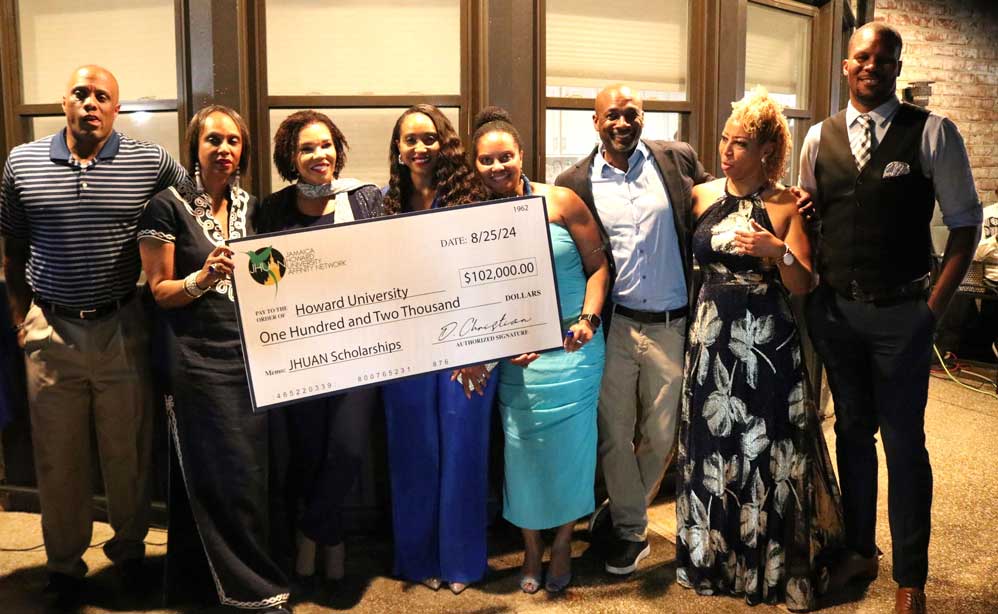 Jamaica’s Ambassador to the United States, HE Audrey Marks poses with members of the JHUAN Executive with the check valued at US $102,000 in scholarships for 25 Jamaican students attending Howard University at the organization's fundraiser held on Saturday September 21.2024  at the Ambassador’s residence in Maryland.  (Photo Derrick Scott)