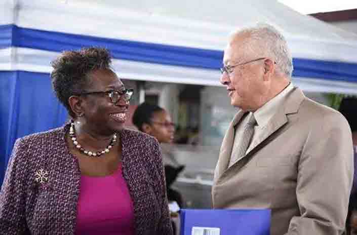 Justice Minister, Delroy Chuck (right) speaks with Director of Public Prosecutions (DPP), Paula Llewellyn, at the opening ceremony of the Ministry's Integrated Justice Fair on October 24,2023  at the Half-Way-Tree Transport Centre, St Andrew.