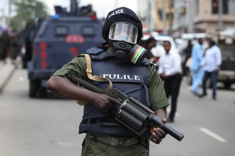 A Nigerian policeman holds a tear-gas launcher in Lagos, Nigeria [Sunday Alamba/AP Photo]