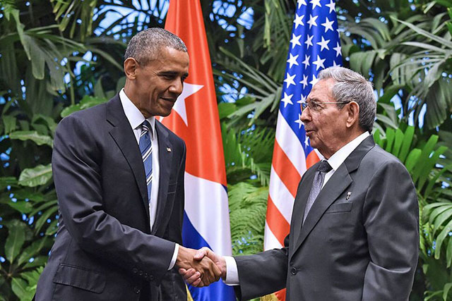 US President Barak Obama greets then Cuban President Raul Castro.