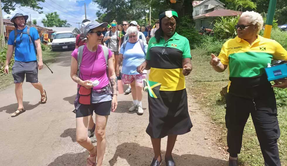 Chair of the Catadupa Tourism Cluster Claudette Glegg (right), and tour guide Marcia Trought-Gordon (left) lead visitors on a tour of the historical sites in Catadupa.