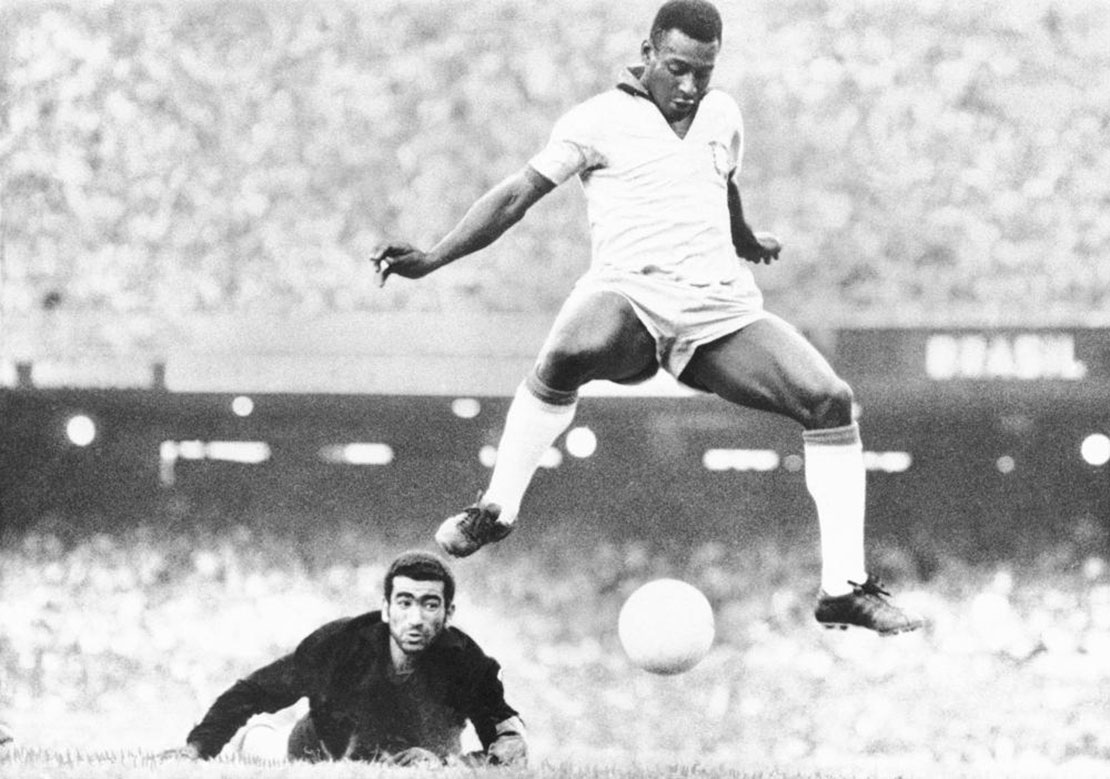 Brazil's Pele scores past Venezuela's goal keeper Fabrizio Fasano in Rio de Janeiro, Brazil, Aug. 24, 1969. Pelé, the Brazilian king of soccer who won a record three World Cups and became one of the most commanding sports figures of the last century, died in Sao Paulo on Thursday, Dec. 29, 2022. He was 82. (AP Photo, File)