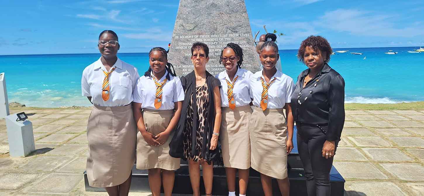 Students gather for a picture at the Cubana memorial in Barbados at the memorial commemmorating the tragedy on October 6.