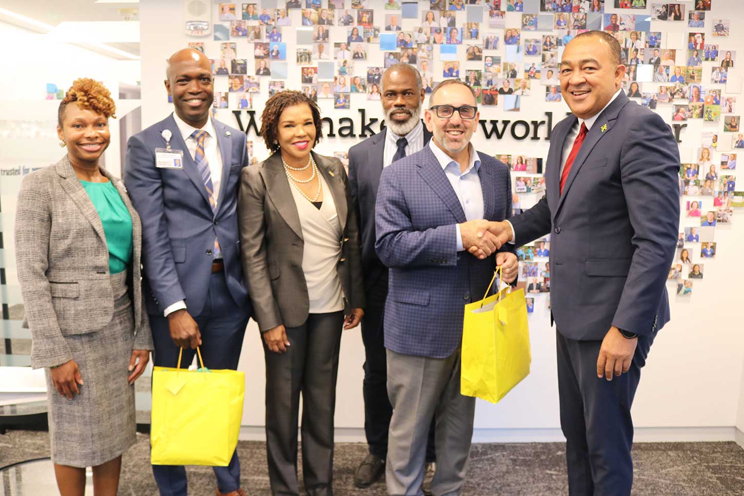 President of Hartford HealthCare Dr. Jeffery Flaks   accepts a gift from Health and Wellness Minister Dr. Christopher Tufton . Looking on from left are Regional President of Hartford HealthCare Gina Calder, Vice President Hartford HealthCare Keith Grant, Jamaica's Ambassador Audrey Marks and UWI Professor Dr Marvin Reid.