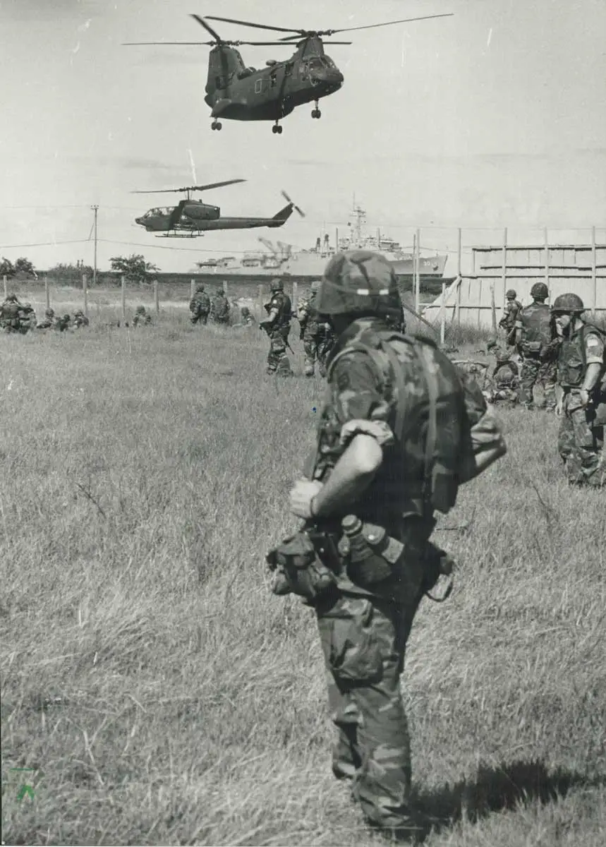 American soldiers watching helicopters during the US invasion of Grenada in October 1983, via the Toronto Public Library