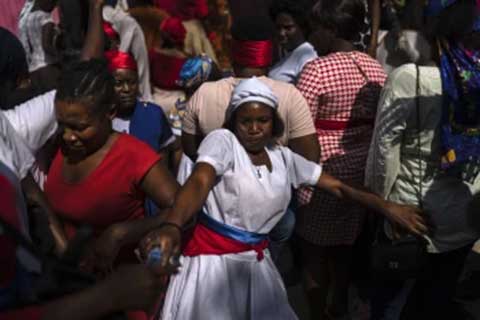 A Vodouist clad in white invokes a gede spirit during the Saint George celebration, in Port-au-Prince, Haiti, April 24, 2024. (AP Photo/Ramon Espinosa, File)