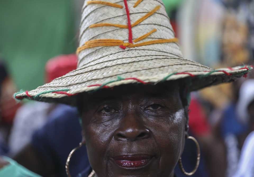 A vodou pilgrim attends a Mass marking the feast day of agriculture and work, in Port-au-Prince, Haiti, May 1, 2024. (AP Photo/Odelyn Joseph, File)