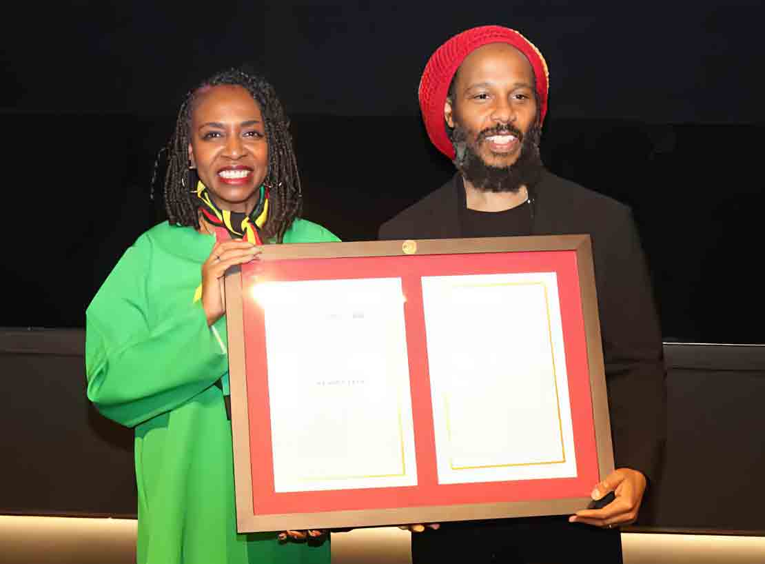 Jamaican-American Congresswoman Yvette Clarke presents A copy of the resolution  to Ziggy Marley, son of Bob Marley, recognize the life and legacy of legendary reggae artist Robert ‘‘Bob’’ Nesta Marley .the presentation was made at a special screening of  the   BOB MARLEY: ONE LOVE film at the Motion Pictures Association in Washington, on Tuesday February 13. (Photon Derrick Scott)